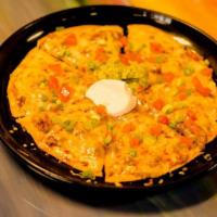 Mexican Pizza · Crispy flour tortilla with choice of meat, refried beans, cheese and garnished with tomatoes...