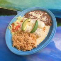 La Isla Enchiladas · Two Enchiladas topped with white creamy alfredo sauce and avocado slices. Served with rice, ...