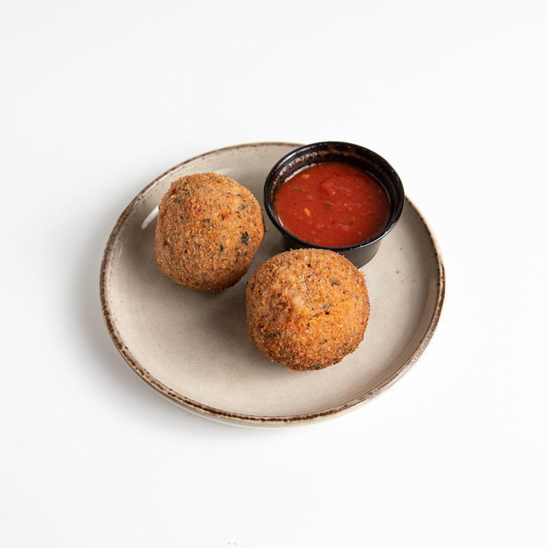 Tomato Arancini · Two tomato risotto balls with a gooey mozzarella center. Served with a side of marinara for dipping.