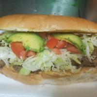 Torta Regular · Beans, cheese, avocado, lettuce, tomatoes, and choice of meat.