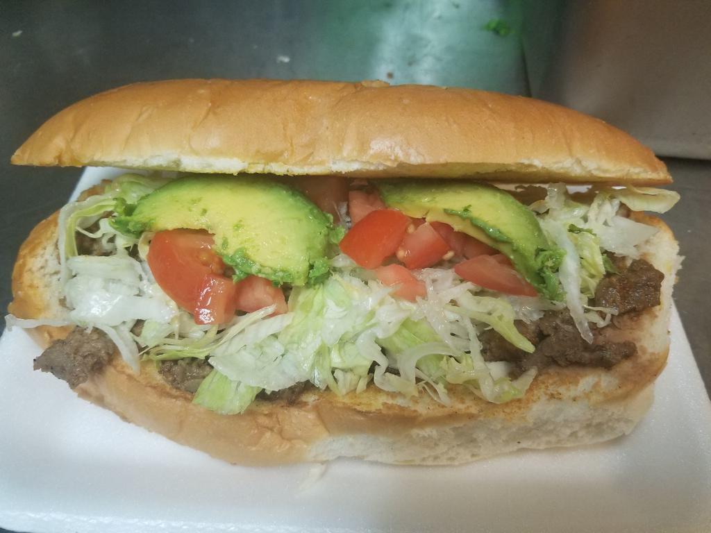 Torta Regular · Beans, cheese, avocado, lettuce, tomatoes, and choice of meat.