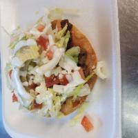 Tostadas · Beans, choice of meat, lettuce, tomato, cheese, sour cream.