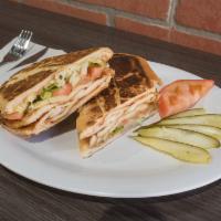 Pollo Sandwich · Chicken. Served with pickles, lettuce and tomatoes.
