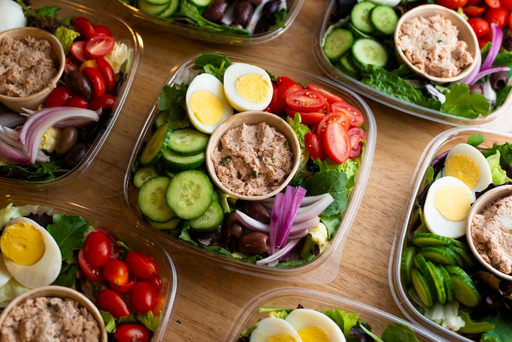 Tuna Salad Platter · Market green salad topped with tuna salad, tomatoes, cucumbers, red onions, hard-boiled egg, and Kalamata olives.