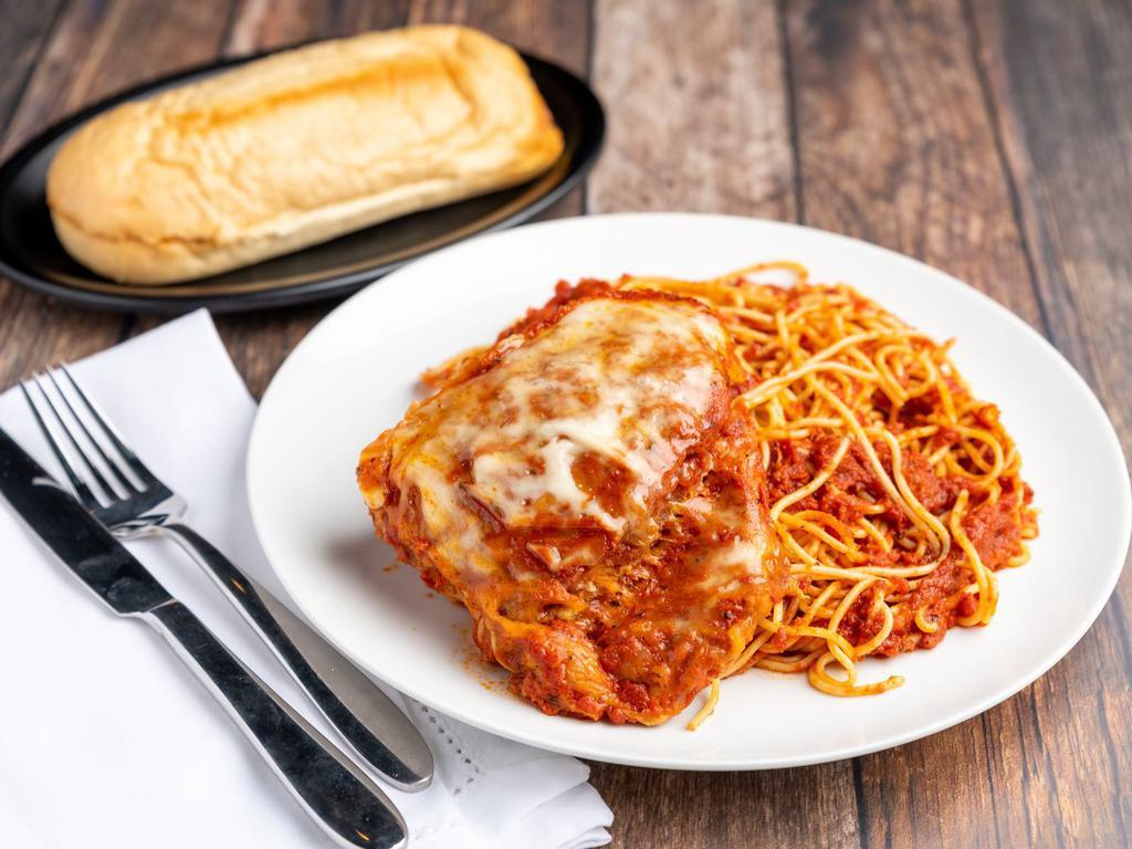 Chicken Parmigiana Dinner · Breaded chicken breast with red sauce and mozzarella, baked to perfection. Served with a side of pasta with red sauce and garlic bread.