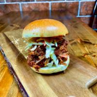 Porky Pig Burger · Pulled pork, homemade BBQ sauce, crunchy slaw, homemade brioche bun.
