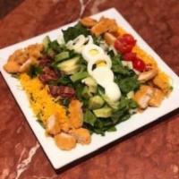 Crispy Chicken Cobb Salad · Fresh romaine lettuce, avocado, bacon, boiled egg, cherry tomatoes, cucumbers and cheddar ch...