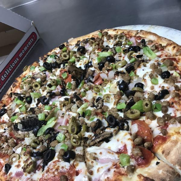 Supreme Pizza · Fresh provolone cheese, pepperoni, Canadian bacon, hamburger, sausage, mushrooms, green olives, black olives, onions and bell peppers.