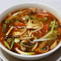 17. Spicy and Sour Soup (Tom Yum)with rice · Tom yum. Bamboo, mushroom, basil, lemongrass, and lime juice. Served with rice.