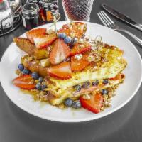 French Toast Sandwich · Stuffed with peanut butter and banana, topped with fresh berries and graham cracker, drizzle...