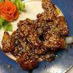 HS13. Sesame Chicken · Chunks of white meat chicken lightly coated with diced onions and scallions. Served in a swe...
