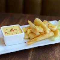 Yuca a la Huancaina · Fried yuca with huancaina sauce, served cold over lettuce leaves and garnished with hard-boi...