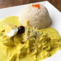 Aji de Gallina · Peruvian chicken stew in aji amarillo sauce over potatoes with eggs, olives and served with ...