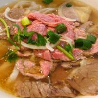 13. Beef Pho · Richly seasoned Vietnamese style beef broth ladled over rice noodles and thin slices of tend...