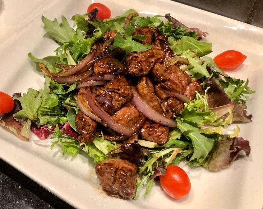 32. Beef Luc Lac  · Cubed beef tenderloin marinated in rice wine, tossed in butter and yellow onions with mixed greens, served with jasmine rice. ***Gluten-free upon request.