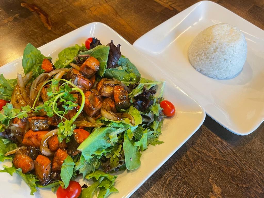 33. Salmon Luc Lac · Cubed wild salmon marinated in rice wine, tossed in butter and yellow onions with mixed greens, served with jasmine rice. ***Gluten-free upon request.