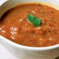 Agraharam Kathrika Gotsu · Eggplant and bell peppers cooked in a tomato and tamarind gravy.