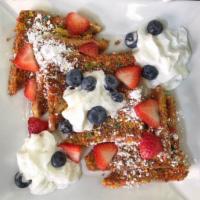 Hendertucky Toast · Fruity pebbles coated French toast, whipped cream, strawberries and blueberries.