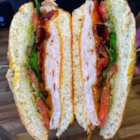Turkey Sandwich · Featuring cheddar, lettuce, tomatoes, onions and our signature sauce. 
