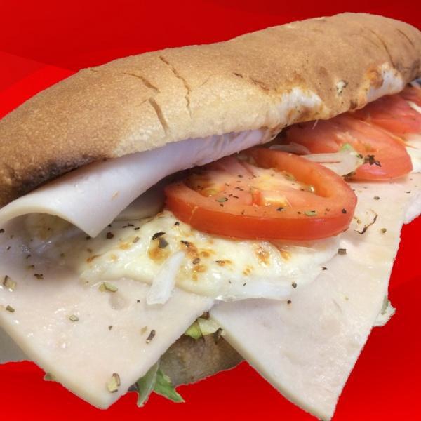 Turkey and Cheese Sub · Dressed with lettuce, tomato, onions, smoked provolone cheese, oil and vinegar and spices.