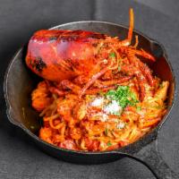 Lobster Pasta · Maine lobster braised in tomatoes, Santorini Island white wine broth, herbs and light cream ...