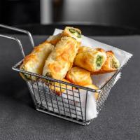 Crispy Spinach and Cheese Pies Plate  · Baked traditional Greek phyllo dough pies.