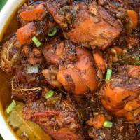 Brown Stew Chicken · Served with 2 sides; rice and peas, white rice, cabbage or collard greens 