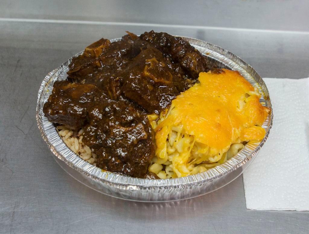 Oxtail · Served with 2 sides; rice and peas, white rice, cabbage or collard greens 