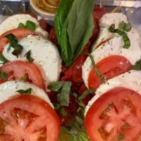Fresh Mozzarella Tomato · Served with roasted peppers, olive oil, and basil.