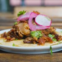 Carnitas Taco · Pork marinated in sour orange and oregano, pickled onions, radishes and cilantro. 