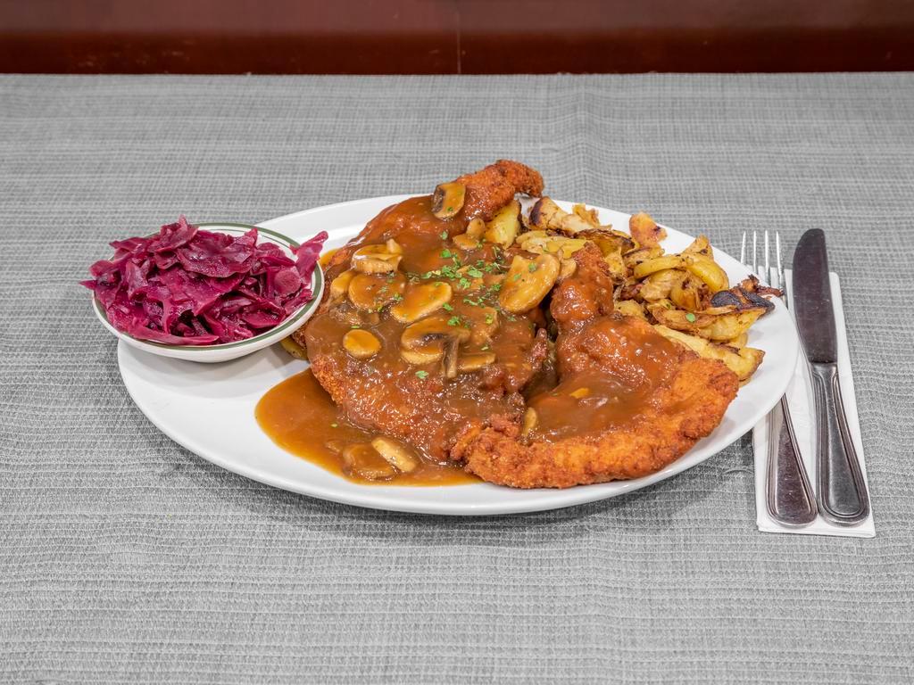 Jägerschnitzel · Breaded and Fried Pork Cutlet with Mushroom Hunter Gravy. Served with Home Fried Potatoes & Red Cabbage.