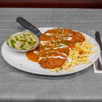 Hungarian Schnitzel · Breaded and Fried Pork Cutlet Covered in Hungarian Paprika Gravy. Served with Spätzle & Cucu...