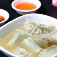 Dumpling Soup 水饺汤 · 8 pieces in house special vinegar soup with dumpling sauce on side.