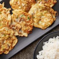 77. Mushroom Egg Foo Young 蘑菇芙蓉蛋 · Served with rice.