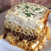 Pastitsio Special · Baked layers of macaroni and ground beef in a light tomato sauce with herbs and spices toppe...