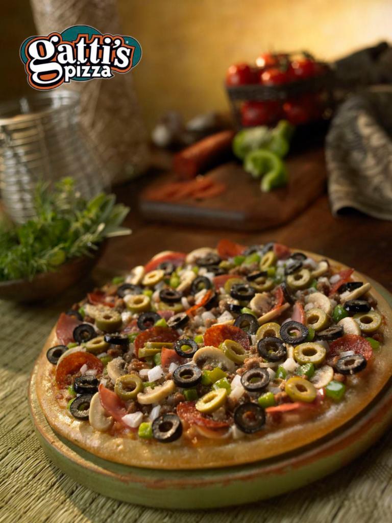 Sampler Pizza · Smoked provolone cheese, pepperoni, Canadian bacon, mild sausage, ground beef, black olives, green olives, white onions, fresh mushroom, and bell peppers.