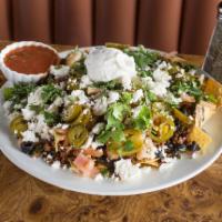 Nacho Platter · Loaded with taco seasoned beef, refried beans, cheese, jalapenos, tomatoes, olives, sour cre...
