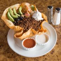 Taco Salad · Our house made shell filled with tender chicken breast or seasoned ground beef, romaine, ref...