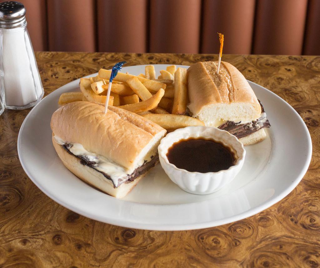 Classic French Dip Sandwich · 1/2 lb. tender eye of the round pilled high with cheese. Au jus on the side.