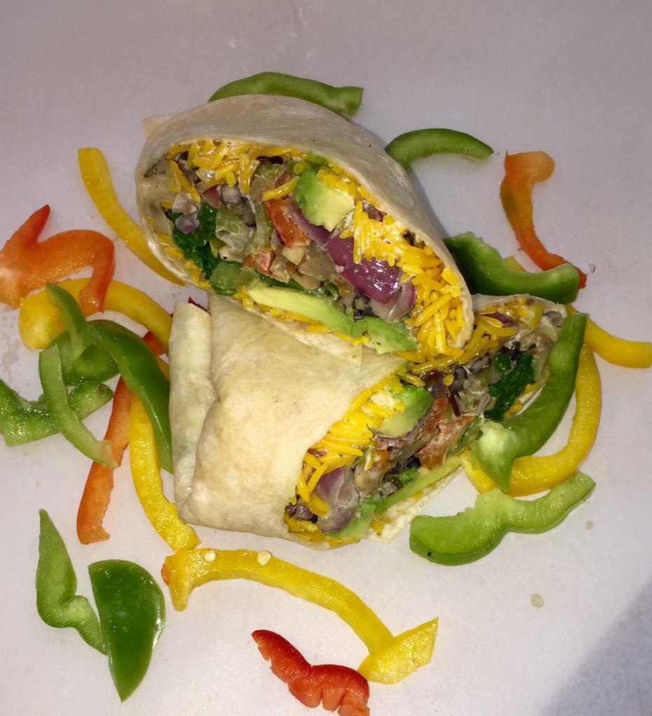 Veggie Burrito · Avocado, spinach, bell peppers, onions, mushrooms, rice, black beans and white sauce.