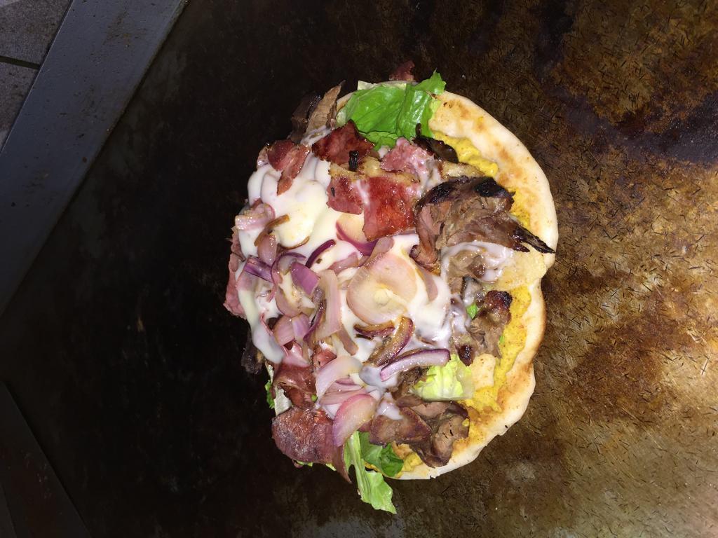 Tompkins · Red pastrami, roast beef, Swiss cheese, grilled onions and lettuce, mustard.