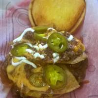 Nacho Daddy Burger · 1/3rd pound Premo Burger flame broiled and topped Nacho style with, tortilla chips, taco mea...
