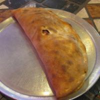 Calzone · A baked or fried turnover of pizza dough stuffed with savory fillings.