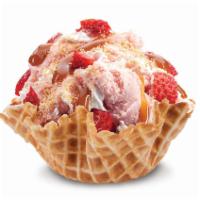 Our Strawberry Blonde Ice Cream · Strawberry ice cream with graham cracker pie crust, strawberries, caramel and whipped topping.
