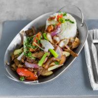Lomo Saltado · Peruvian stif-fried beef with red onions, tomatoes, soy sauce, and cilantro, served with ric...