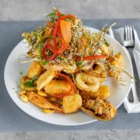 Jalea · Catch of the day, shrimp, mussels, and calamari seved with fried yucca and salsa criolla.
