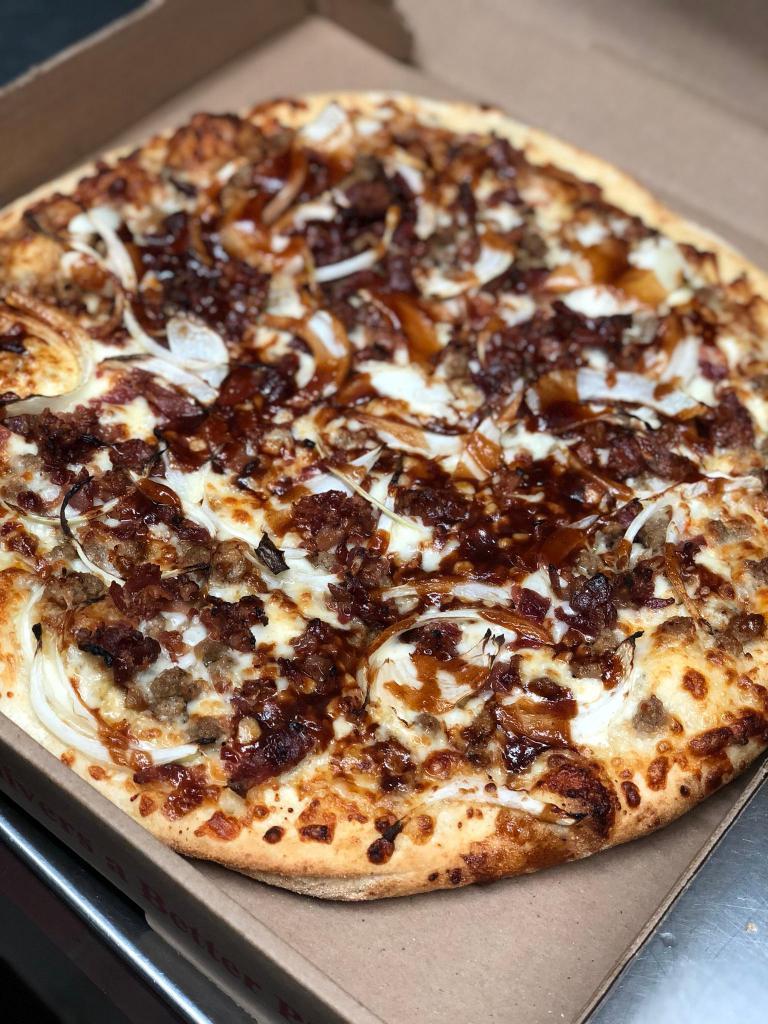 Smokey BBQ Chicken Pizza · BBQ chicken, sliced onions with mozzarella and Parmesan cheese.