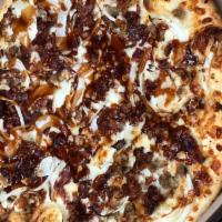 Bacon Cheeseburger Pizza · Beef, onions, and bacon in BBQ sauce with mozzarella and cheddar cheese.
