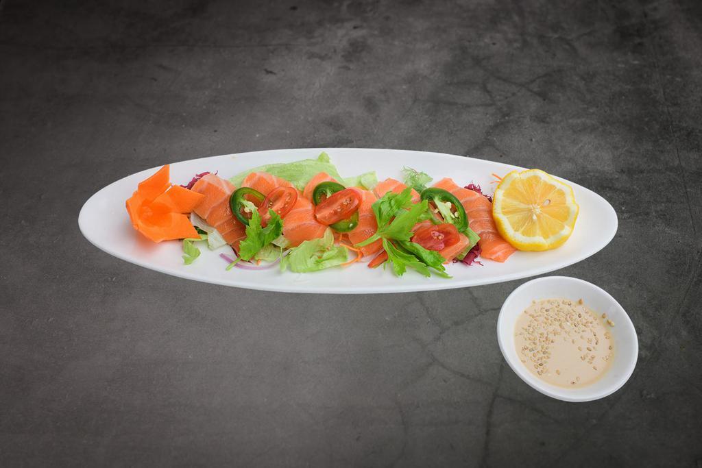 Salmon Tataki · Seared premium salmon with black pepper toasted sesame topped with thinly sliced tomato and jalapeno in sesame vinaigrette
