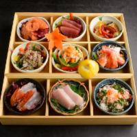NorikoH Deluxe Box · 9x course of delectable raw and cooked cuts, adorning sushi rice in lacquer bowls in a woode...